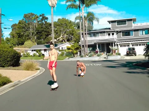 Longboard boys railing rigid on a catch